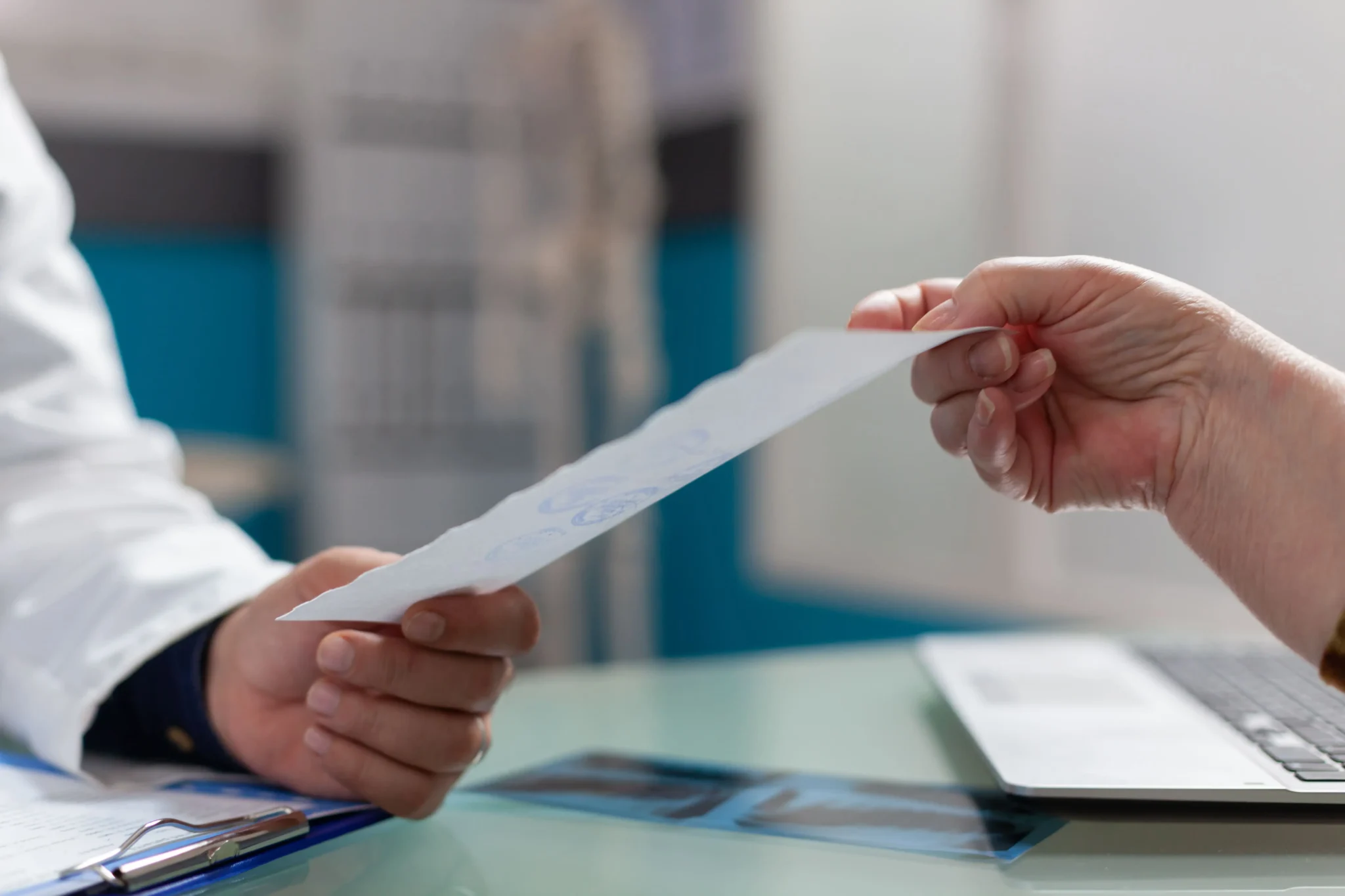 Healthcare provider handing a document to a patient